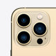 Close-up of a smartphone camera module with three lenses on a beige background
