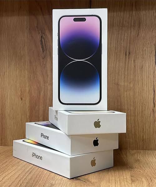 Stack of Apple iPhone boxes on a wooden surface
