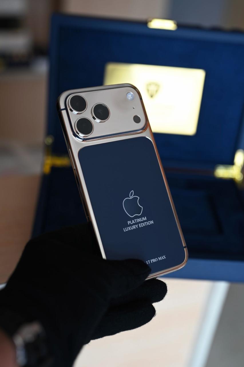 Smartphone with 'Platinum Luxury Edition' branding held by a person wearing a black glove.